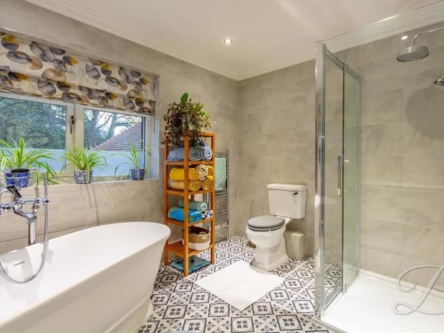 A second look at the bright and colourful family bathroom, showing a spacious walk-in shower cubicle.