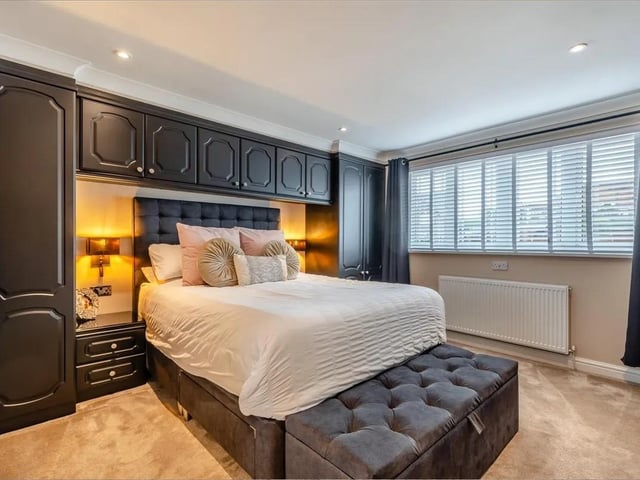 Having extensive fitted wardrobes with hanging rails and shelving, plus dressing table with glass top and ample drawers beneath. Four ceiling spotlights, coving to ceiling and double glazed window to the front elevation.