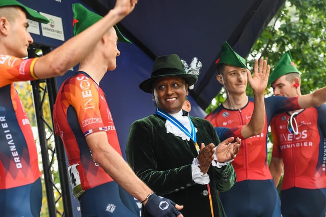 Tom Pidcock, Carlos Rodriguez, Luke Rowe, Connor Swift, Magnus Sheffield and Ben Turner of Team INEOS Grenadiers before the start of Stage 4 of the 2023 Tour of Britain in Sherwood Forest wearing Robin Hood hats alongside The High Sheriff of Nottinghamshire, Professor Veronica Pickering DL.