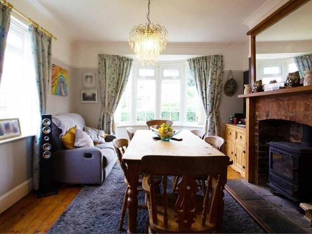 The second reception room is also bright, warm and comfortable. There are large windows to the front and side, while a focal point is another exposed-brick feature fireplace surround with a tiled hearth housing a log burner.