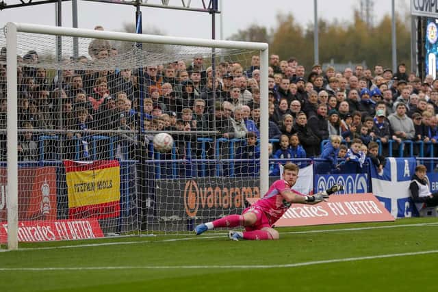 Lucas Akings fires Mansfield Town ahead at Curzon Ashton from the penalty spot.