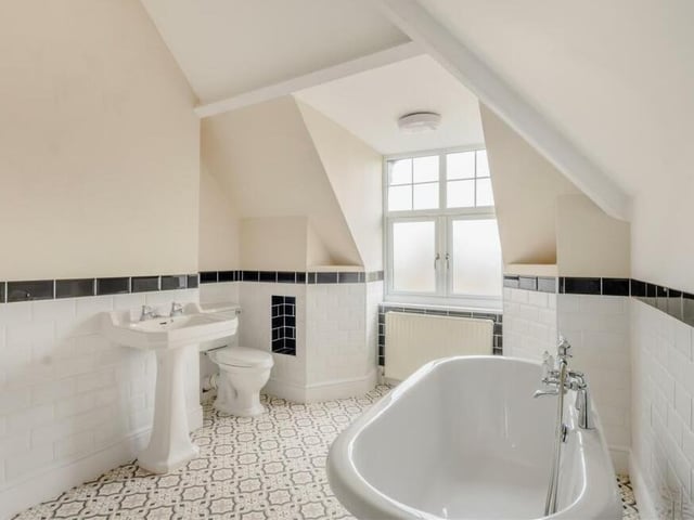 Here is the family bathroom, which can also be found on the second floor. A four-piece white suite includes a free-standing roll-top bath with claw feet, mixer tap and shower handset, plus a pedestal wash hand basin and low-flush WC.