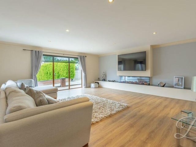 Our photo gallery begins in the fabulous living area, with its laminate flooring, electric fireplace, downlights and patio doors leading outside.