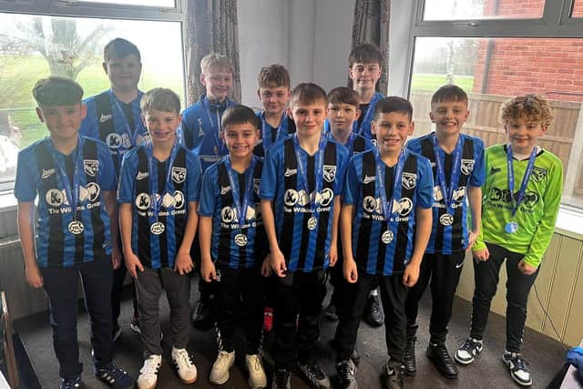 A moment to remember as these youngsters collect their league winner medals.