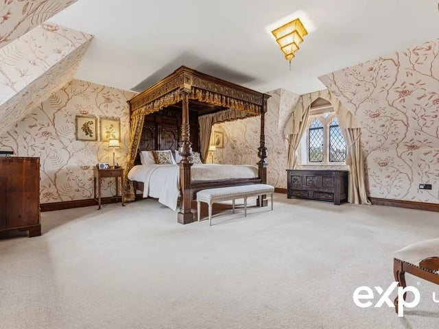 This vast principal bedroom includes fitted wardrobes