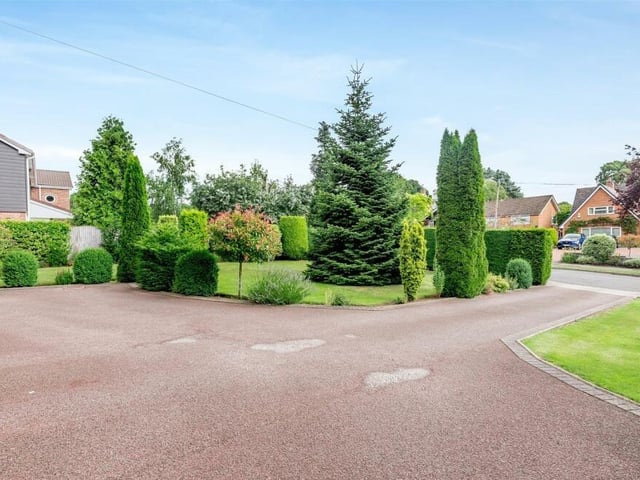 The £720,000 house stands well back from the road, with a sweeping driveway offering ample space for off-street parking.