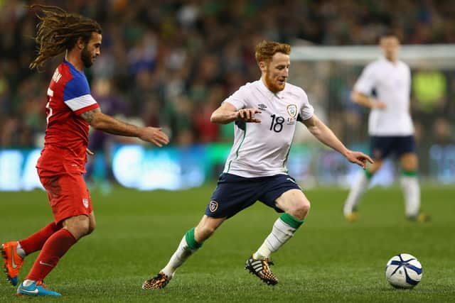 Stephen Quinn (R) of Ireland is tracked by Kyle Beckerman (L) of USA in 2014.