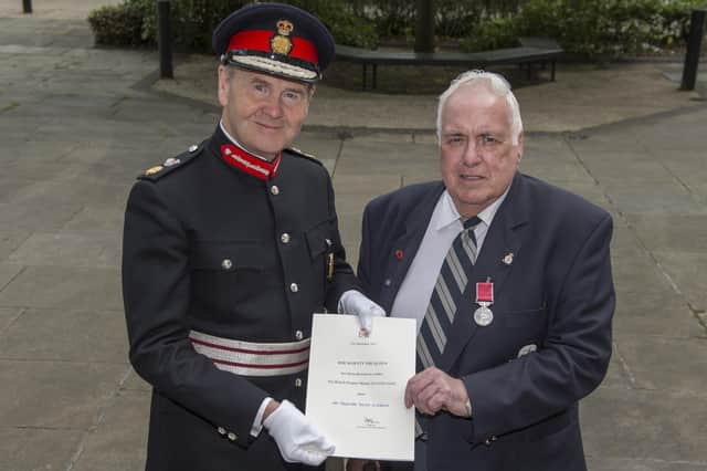 Malcolm Scothern, of Kirkby, receives the British Empire Medal from Sir John Peace, Lord-Lieutenant of Nottinghamshire, in 2016.