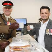 Cheers! Lt Col Keith Spiers (left), of the Army, who performed the opening ceremony, shares a cuppa with former soldier Andy Brewster, the businessman behind Spectre Coffee.