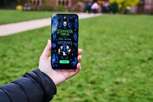 Family exploring the park on the Halloween-themed activity using the new interactive app