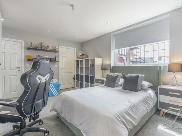 Bedroom number two, which overlooks the front of the house, is also a good size. It boasts a carpeted floor, downlights and access to office space.