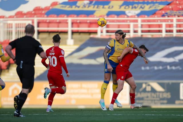 Aden Flint wins his header during the Sky Bet League 2 match against Swindon Town FC at The County Ground, 25 Nov 2023. 
Photo credit Chris & Jeanette Holloway / The Bigger Picture.media