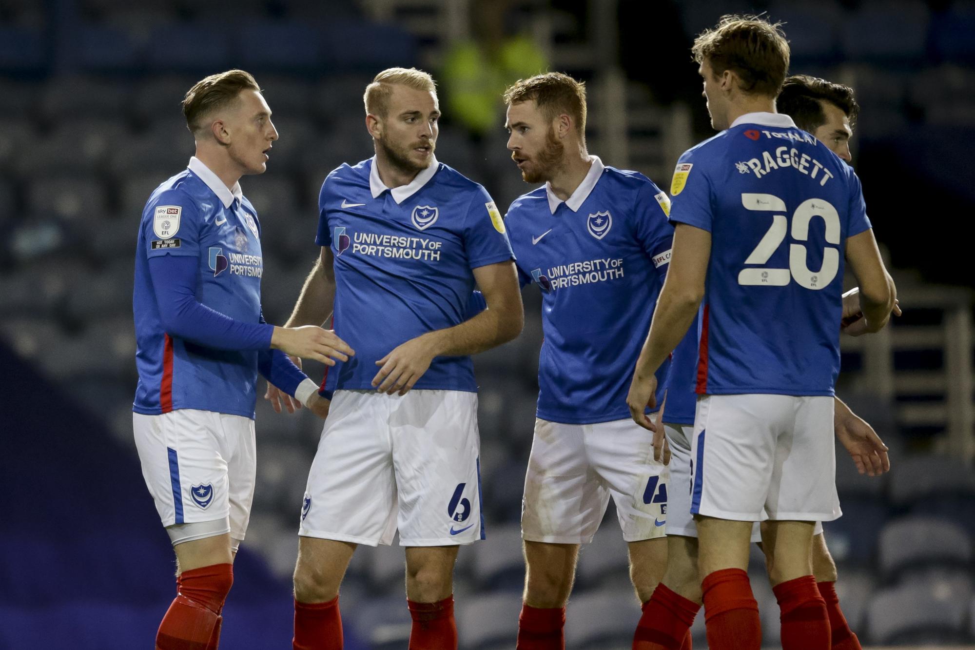 PORTSMOUTH, ENGLAND - OCTOBER 27: Ronan Curtis of Portsmouth FC scores a goal to make it 3-0 and is congratulated by team-mates during the Sky Bet League One match between Portsmouth and Northampton Town at Fratton Park on October 27, 2020 in Portsmouth, England. Sporting stadiums around the UK remain under strict restrictions due to the Coronavirus Pandemic as Government social distancing laws prohibit fans inside venues resulting in games being played behind closed doors. (Photo by Robin Jones/Getty Images)
