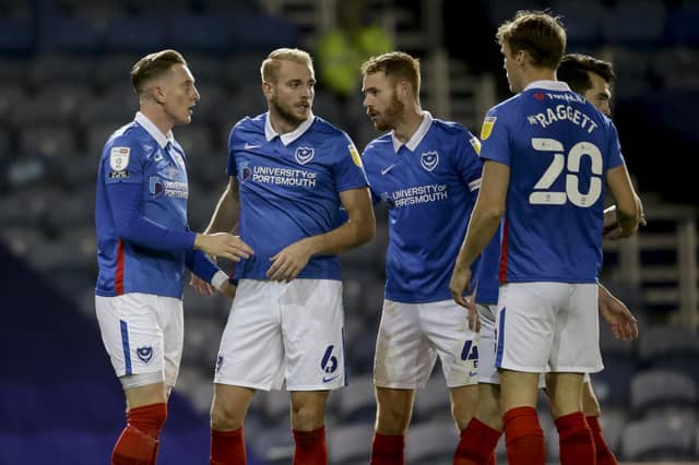 PORTSMOUTH, ENGLAND - OCTOBER 27: Ronan Curtis of Portsmouth FC scores a goal to make it 3-0 and is congratulated by team-mates during the Sky Bet League One match between Portsmouth and Northampton Town at Fratton Park on October 27, 2020 in Portsmouth, England. Sporting stadiums around the UK remain under strict restrictions due to the Coronavirus Pandemic as Government social distancing laws prohibit fans inside venues resulting in games being played behind closed doors. (Photo by Robin Jones/Getty Images)