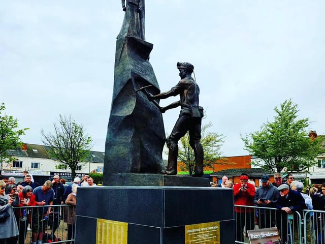 Residents gather by the statue to have a closer look.