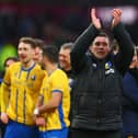 Nigel Clough applauds fans on the pitch after the FA Cup fourth round football match between Burnley and Mansfield Town at Turf Moor in Burnley on February 14, 2026. (Photo by Paul Currie / AFP via Getty Images)