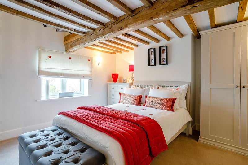 The second bedroom features original, exposed beams.