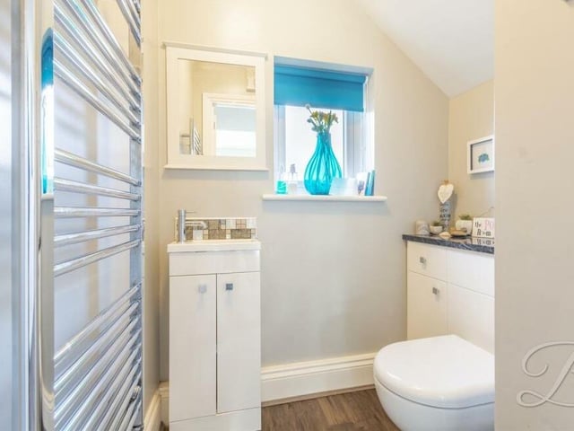 The ground floor also houses this toilet, complete with low-flush WC, wash hand basin and storage space.