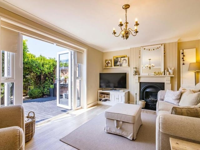 This lovely lounge is an ideal place to start our tour of the Kimberley house. It features a cast-iron fire with wooden fireplace surround and large French doors leading out to the back garden.