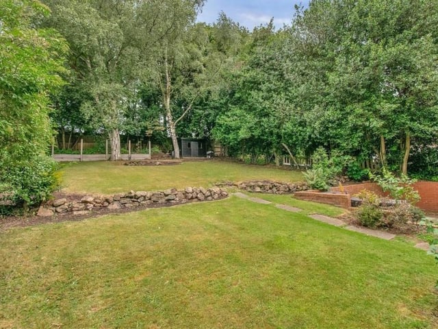 The main garden at the back is laid to lawn, with rockery features. It is bordered by a variety of mature trees, as well as an established hedgerow.