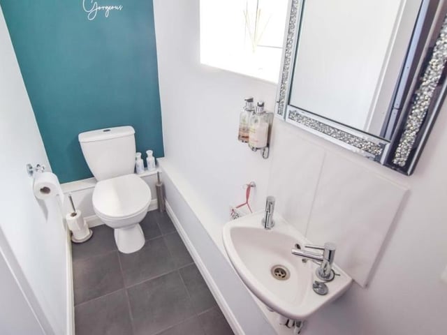 A downstairs toilet is always handy, especially when it boasts a large mirror above the hand wash basin.