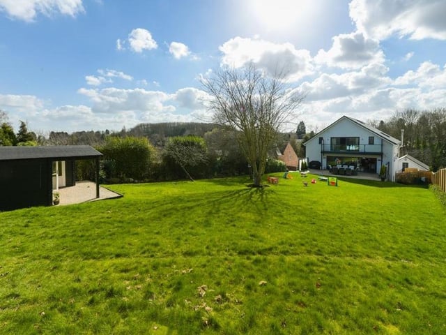 Here is the view from the back of the house, showing the extensive garden and a summer house.