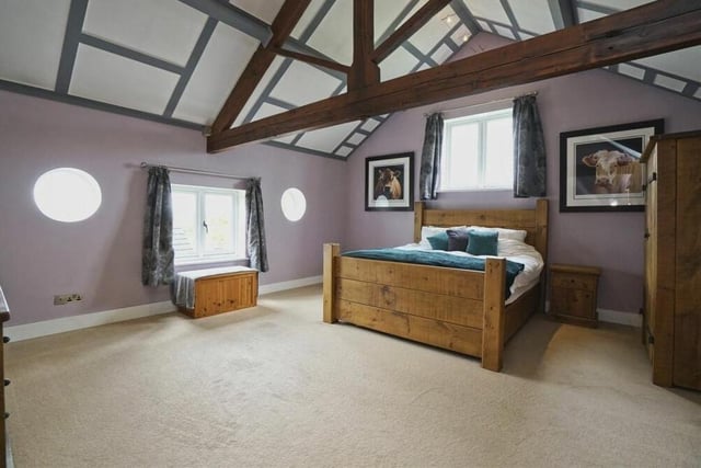 As well as ceiling beams, the master bedroom features eyecatching porthole windows.