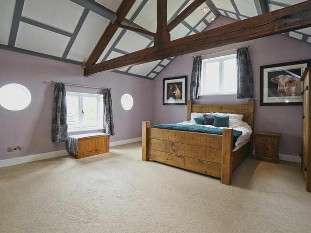 As well as ceiling beams, the master bedroom features eyecatching porthole windows.