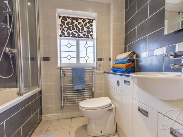 Complementing the four bedrooms on the first floor is this stylish family bathroom. It consists of a fitted bath with overhead shower, low-flush WC, vanity hand wash basin, chrome, heated towel-rail and full-height tiling.