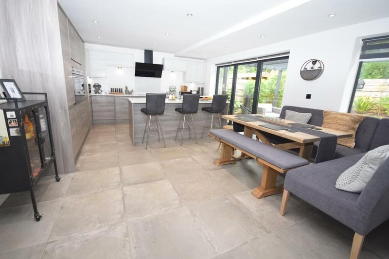 Time now for our first look at the stunning open-plan kitchen/diner, which also includes a living area. It spans the rear of the £600,000 property. In the foreground is a seating area where the family can get together.