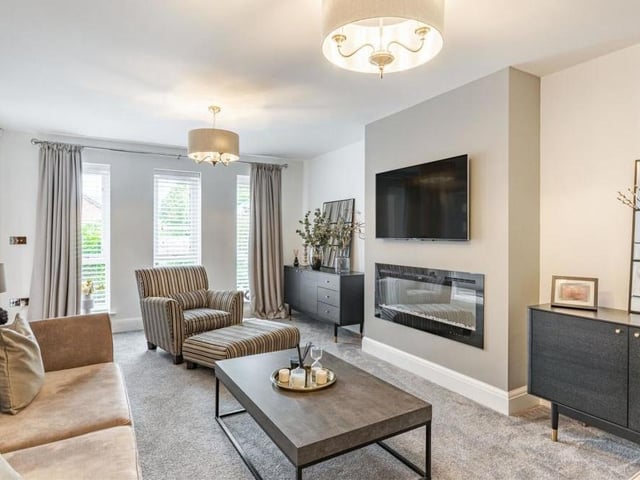 The lounge is bright and light thanks to three floor-to-ceiling, double-glazed windows facing the front of the property.