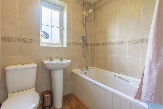 The main bathroom can be found in the centre of the first floor. It is fitted with a three-piece suite, comprising panelled bath with overhead shower, pedestal sink, low-flush WC, full-height tiling in a neutral colour and an opaque window to the side of the house.