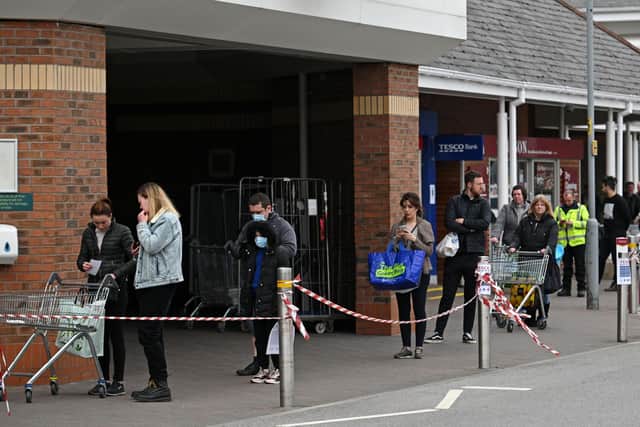 Shoppers queue using social distancing outside a Tesco supermarket (Photo by Oli SCARFF / AFP) (Photo by OLI SCARFF/AFP via Getty Images)