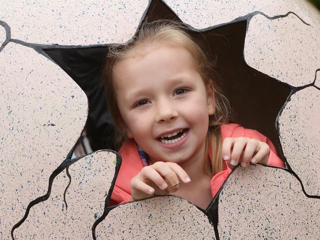 Paisley Thellman ready to hatch from a giant egg at Jurassic Mansfield.
