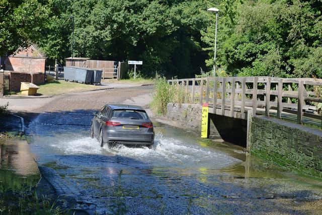 A car drives through Rufford Ford.