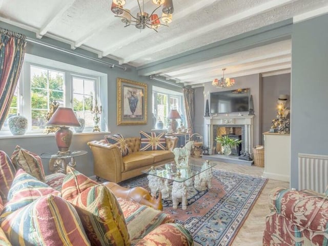 We told you this property had personality and character -- and here it is, in full view in the homely living room! With exposed ceiling-beams, a feature log-burner and triple-aspect windows, it is a beautiful and comfortable space.