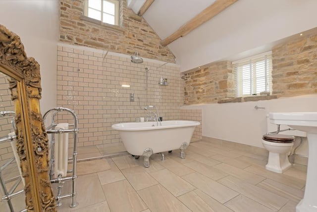 This is the master en-suite, with a freestanding bath and a large walk-in enclosure with a fitted rain head shower.