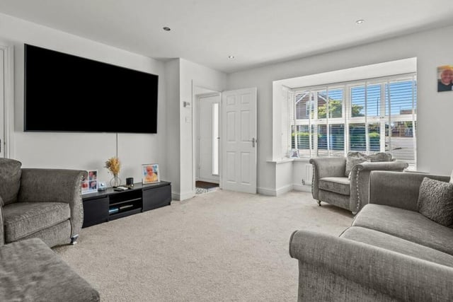 Moving on now into the bay-fronted main lounge or family living room at the Mansfield Woodhouse property. Relax in front of the big-screen TV.