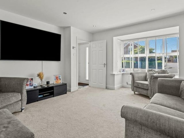 Moving on now into the bay-fronted main lounge or family living room at the Mansfield Woodhouse property. Relax in front of the big-screen TV.