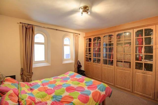Located on the ground floor, this bedroom comes with a range of fitted wardrobes and bathroom access.