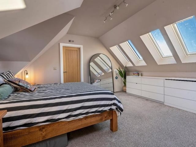 A second shot of the bright and bonny master bedroom at the £470,000 Forest Road property. Four double-glazed Velux windows overlook the front of the house.