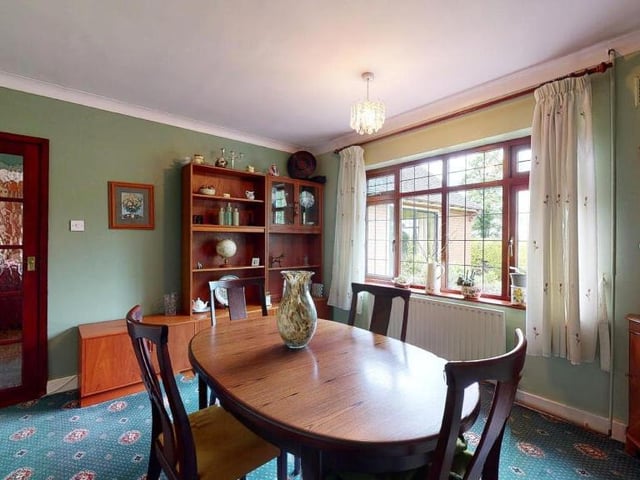 This room is currently being used as a delightful dining room, with fine views from the window of open fields. But it could also be converted into the bungalow's fourth bedroom if necessary.