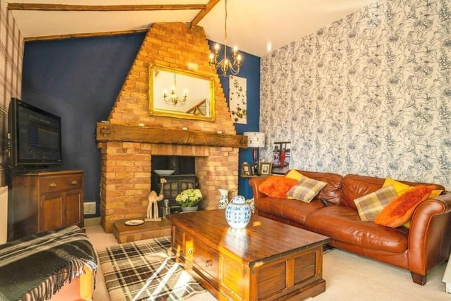 Let's begin our tour of the Selston bungalow in the cosy lounge, which is distinguished by an open, brick feature fireplace with multi-fuel log-burner.