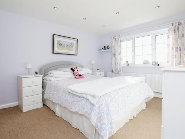 Moving upstairs, it's time to take a look at the bedrooms. The master is a spacious double that overlooks the front of the house. It has access to an en suite bathroom, which comprises an enclosed shower cubicle, wash hand basin and WC, with spotlights and fully tiled walls and floor.