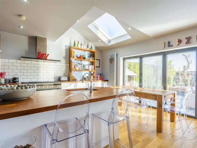 There is a breakfast bar and room for a large dining table.