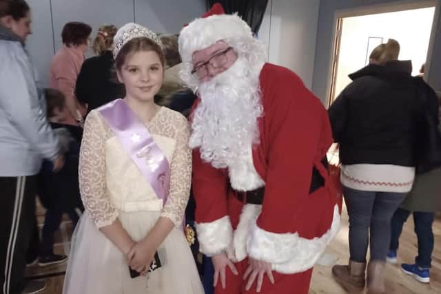 Paige Lest, the Gala Queen, with Santa.