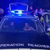 Youngsters inspect an Operation Reacher police vehicle.