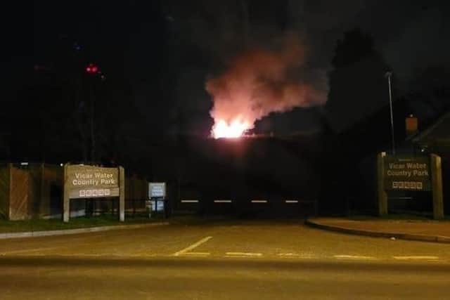 Flames, which could be seen several miles away, rise into the sky during Sunday night's fire at Vicar Water Country Park in Clipstone