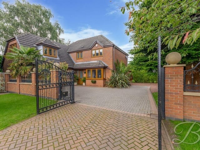 Our final photo shows the imposing gates that open on to a private driveway at the front of the house.