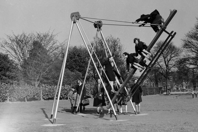 Children on swings in Beveridge Park, Kirkcaldy,  Fife.